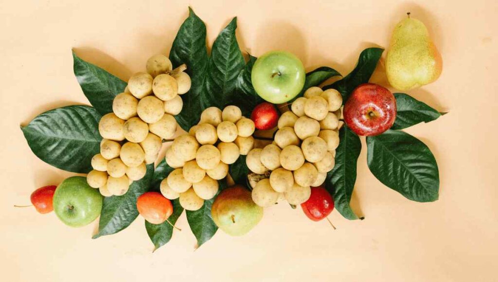 Bunches of single fruit longan seen with other fruits.